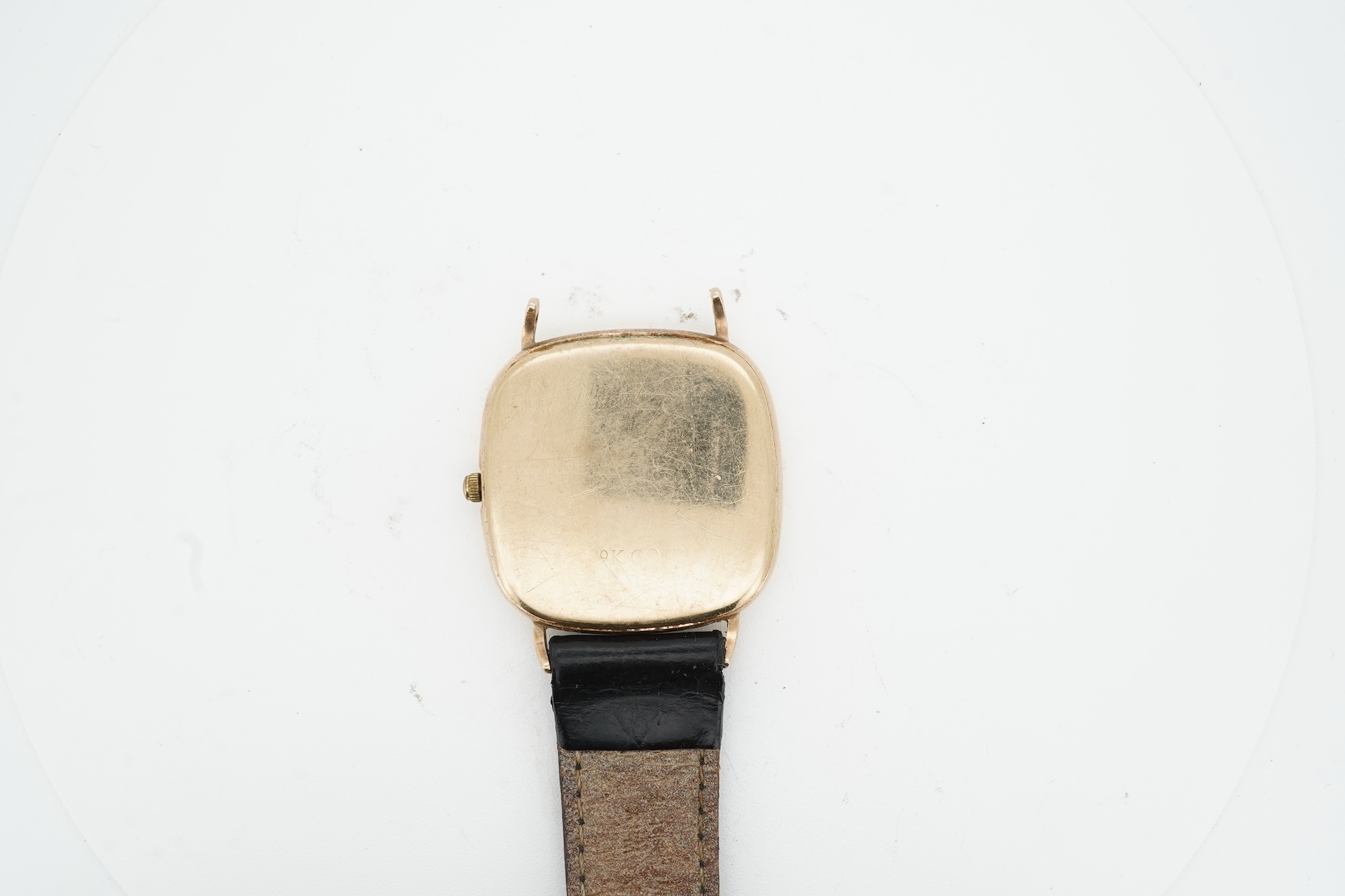 A gentleman's recent 9ct gold Rotary quartz wristwatch, with shaped square dial, baton numerals and date aperture, case diameter 30mm, part of associated leather strap missing.